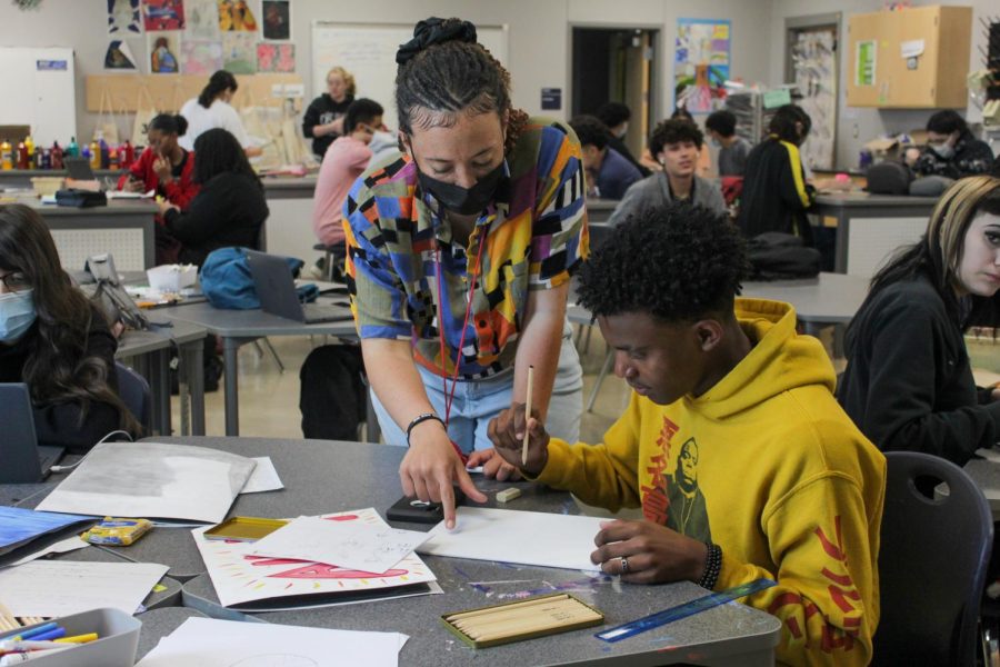 In one of the many art classes at VMHS, Khadijah Green-Gaskin instructs a student about how to create perspective in painting.