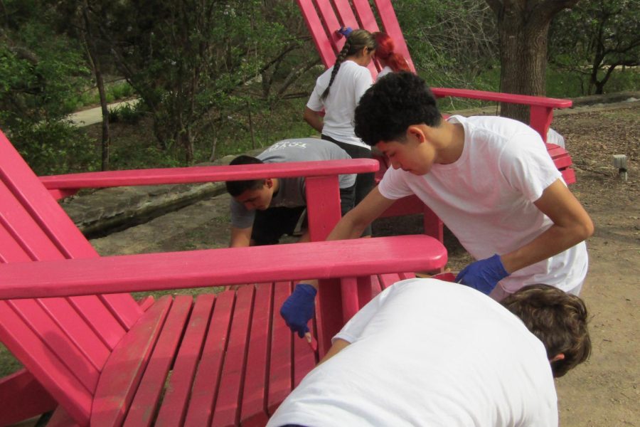 (lLeft to right) Cadets PFC Aiden Holcom,PFC Brandon Garcia, PFC Cayden Richardson, 2LT Brianna Munoz, 1LT Eliana Delvalle,   and graduated volunteer Alfredo Cardenes add a fresh coat of paint to the oversized seats that decorate the grounds of the SA Botanical Gardens.
