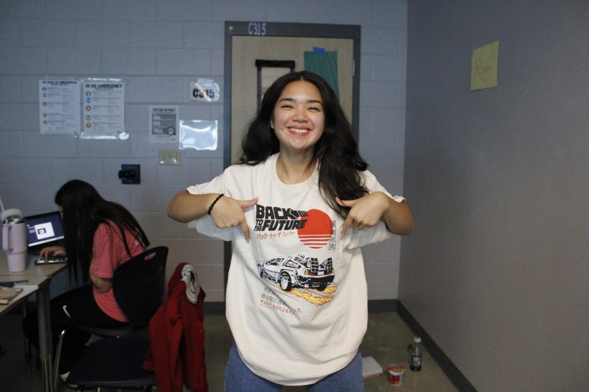 Jia Urquico, sophomore, poses with her Back To The Future shirt for spirit week.