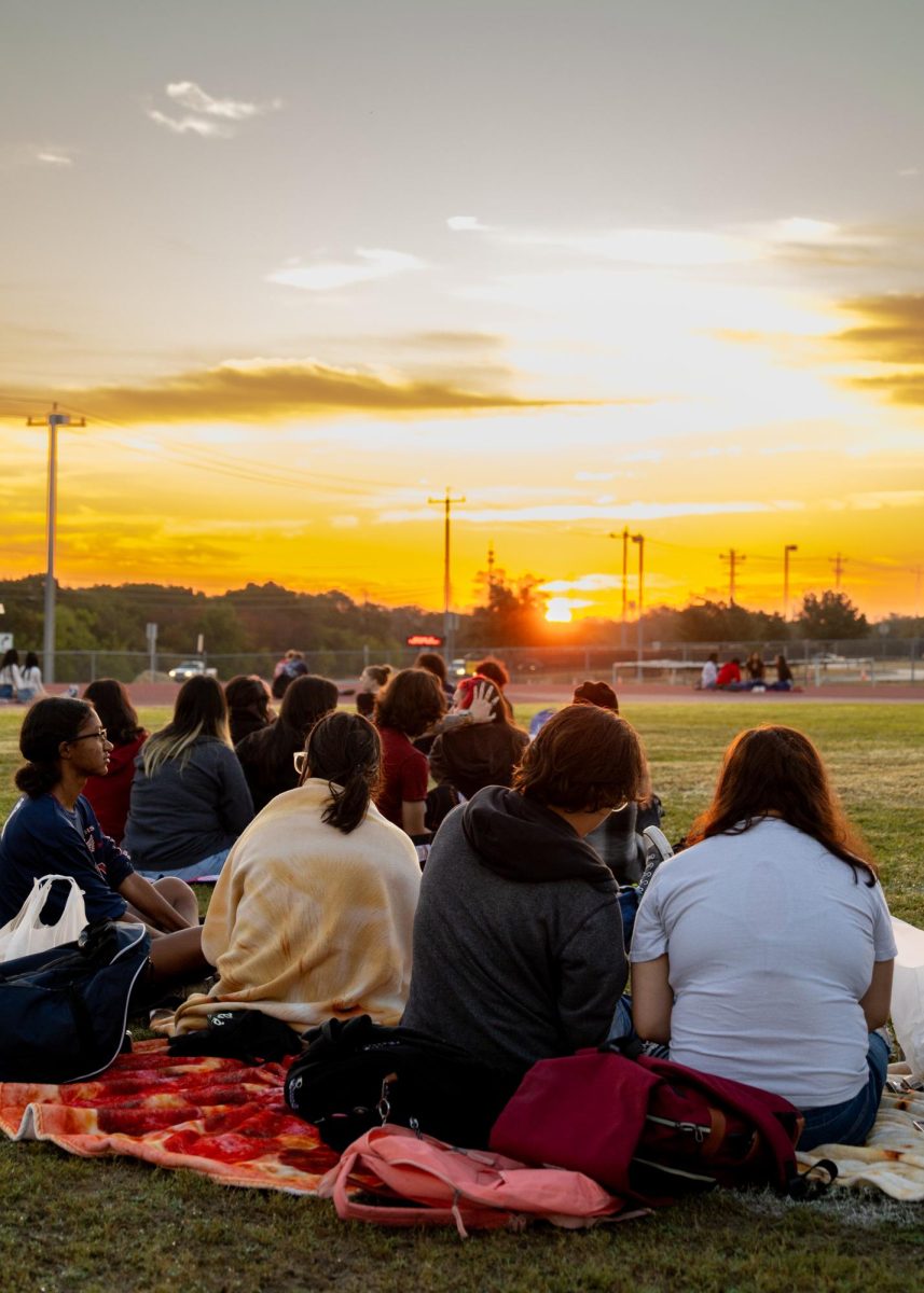 Seniors gather on the football field to watch the sunrise over their final year at VMHS on Oct. 6.  Senior Sunrise is a tradition observed at the beginning of every school year to kick off the graduating class last year and is mirrored at the end of the year with Senior Sunset.