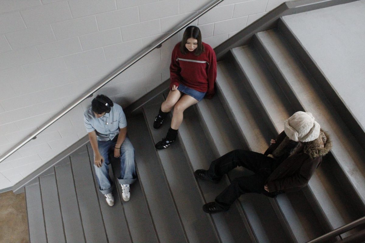 Sergio Balderas, sophomore, Annabelle Martinez, junior and Joshua Allen , sophomore rest on the stairs at VMHS