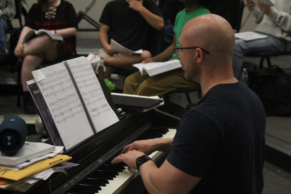 Stanley Moody plays piano for students at Legally Blonde practice on April 4, 2024