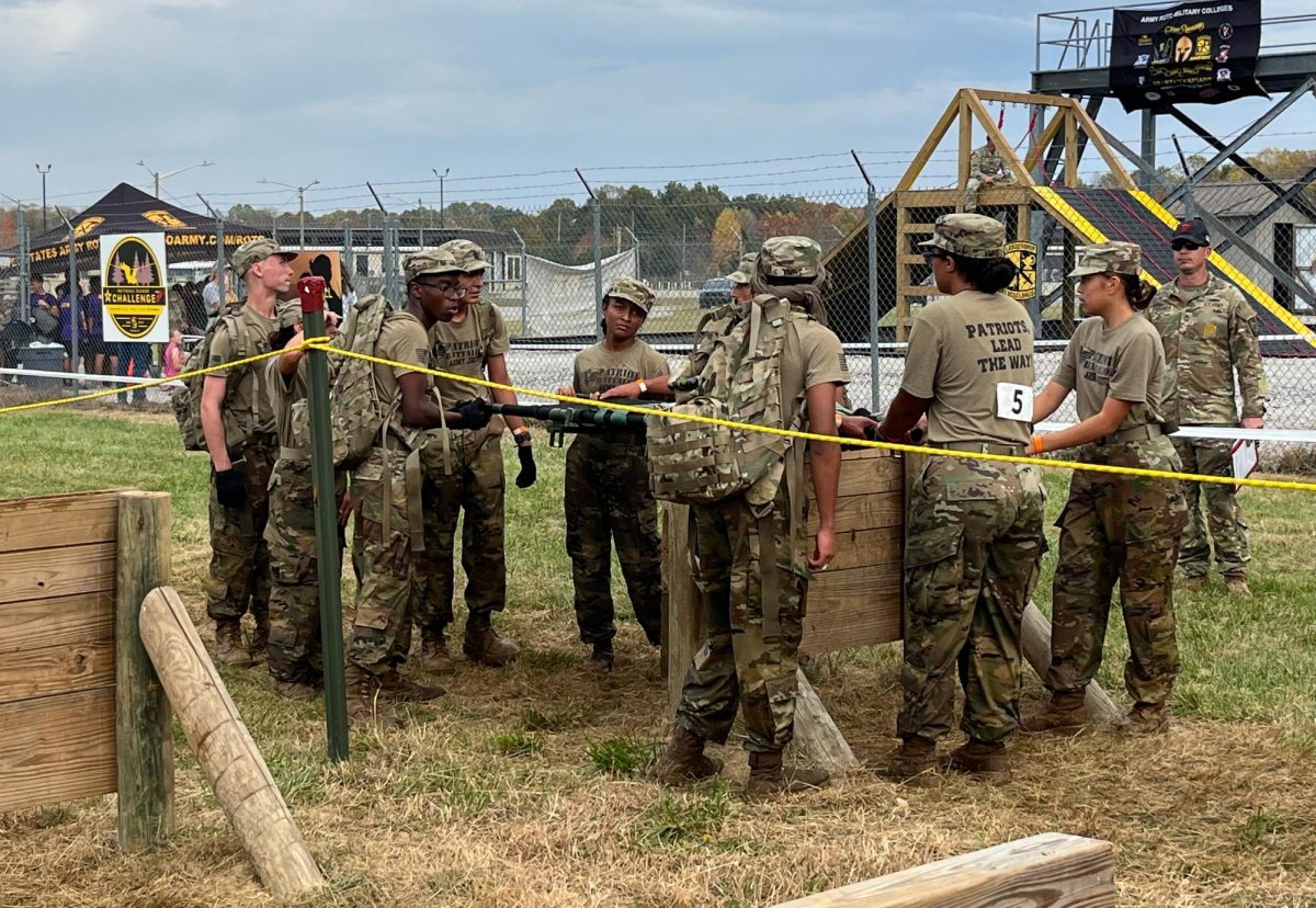 The Patriot Raider team enduring obstacles with 35-pound rucksacks and a 130-pound stretcher during the cross country-rescue.