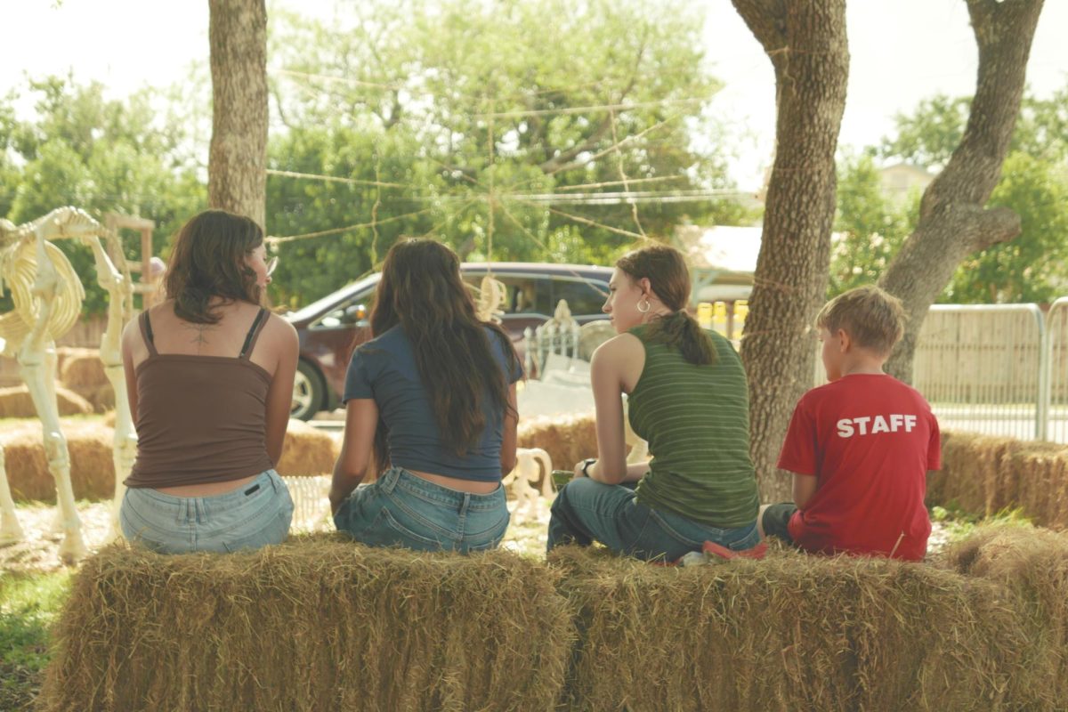 Seniors Raina Samosorn (left), Malorey Zamora (left center), Sophomore Olivia Memelo (right center) and staff director’s son Cylus (right), resting after the first hour of volunteering. They plan for next course action under the shade, waiting for a moment of cloud cover before returning to work.